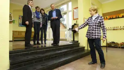 Noch nicht barrierefrei: Christine Grimpe (r.) zeigt Horst Wiesch (v.l.), Marlies Plate, Cattrin Siemers und Wolfgang Griese, dass im Zuge der Inklusion noch eine Lösung für die Treppe gefunden werden muss.