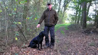 Jagdpächter Dieter Fricke mit seinem Hund Ivo auf dem Weg, an dem der tote Wolf lag.