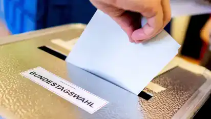 Ein Wähler wirft in einem Wahllokal seinen Stimmzettel für die Bundestagswahl in eine Wahlurne. (Archivbild)