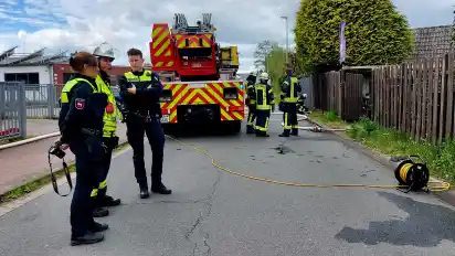 An der Klosterweide in Lilienthal hat am Karsamstag eine Garage gebrannt. Vor Ort beraten Kräfte von Polizei und Feuerwehr über die Lage.