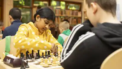 Sripada, das einzige teilnehmende Mädchen, spielt gegen John. Beide sammeln erste Turniererfahrungen.