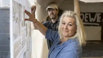 Ilke von Welawitsch und ihr Ehemann Andy informieren auf Plakaten über den Umzug von Illy's Livingroom aus dem Bremer Viertel nach Borgfeld.